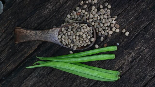 Cluster beans or gawar phali (guar) seed on wooden background, Cyamopsis tetragonoloba