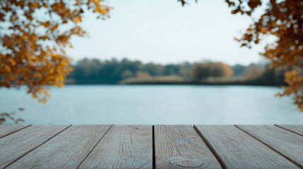 Wooden table, serene lake vista framed by autumn's golden leaves, evokes Harvest Festival and National Day of Listening