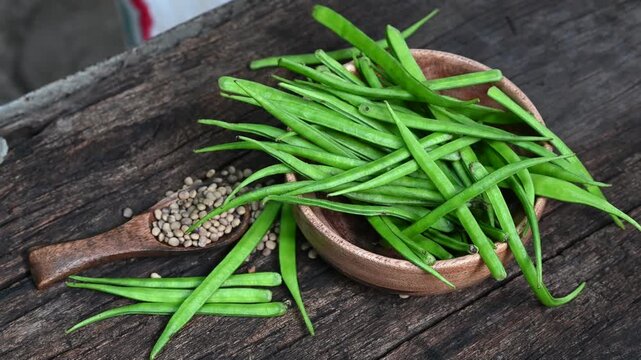 Cluster beans or gawar phali (guar) seed on wooden background, Cyamopsis tetragonoloba
