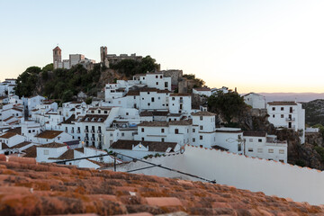 Casares, Andalusia, Spain. 5 September 2025. Rooftops with mountain landscape at sunset.