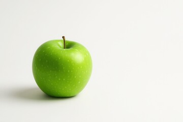 Fresh green apple on clean white background with copy space minimal healthy lifestyle concept for nutrition wellness and organic food marketing