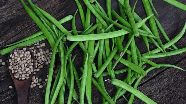 Cluster beans or gawar phali (guar) seed on wooden background, Cyamopsis tetragonoloba