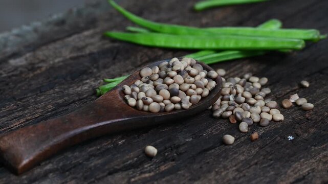 Cluster beans or gawar phali (guar) seed on wooden background, Cyamopsis tetragonoloba