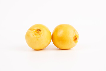 Two round, yellow dates are placed next to each other on a white background.