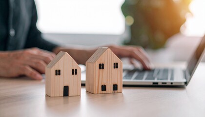 Wooden House Models and Laptop: Real Estate Investment Concept.