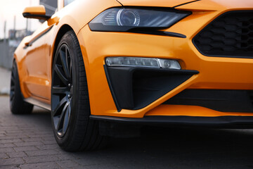 Modern cabriolet parked on stone pavement outdoors, closeup
