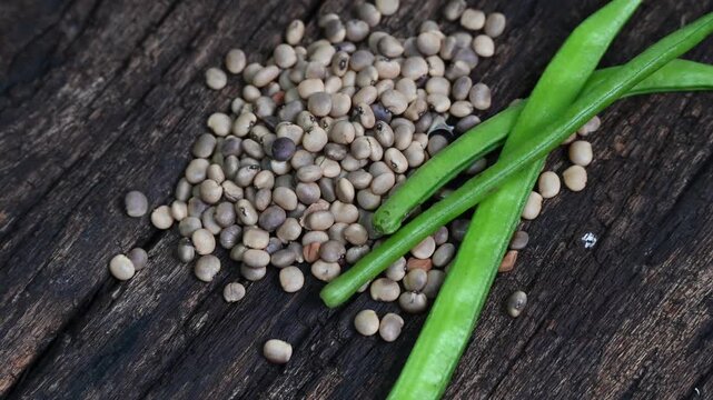 Cluster beans or gawar phali (guar) seed on wooden background, Cyamopsis tetragonoloba