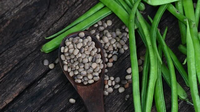 Cluster beans or gawar phali (guar) seed on wooden background, Cyamopsis tetragonoloba