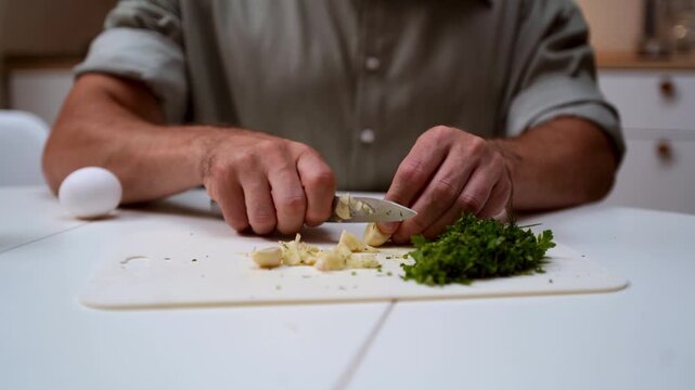 A chef professionally prepares a fresh vegetable salad, chopping potatoes, eggs, and greens. Dynamic cooking process showcasing culinary skills and healthy food preparation
