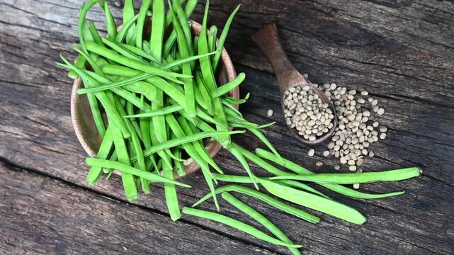 Cluster beans or gawar phali (guar) seed on wooden background, Cyamopsis tetragonoloba