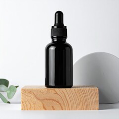 Black glass dropper bottle on light wood block against white backdrop, minimalist aesthetic with subtle grey circle and eucalyptus sprig