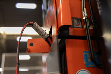 Close-up of industrial power connector plugged into a forklift or warehouse equipment, highlighting modern charging system, electrical safety, and energy connection in industrial environments. © eakgrungenerd