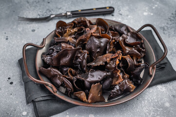 Fresh wood ear mushrooms, perfect for adding unique texture and flavor to your favorite Asian dishes. grey background. top view