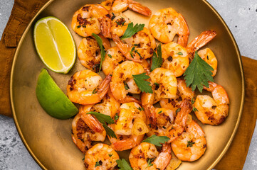 BBQ dinner with roast Shrimps Prawns in a plate. Gray background. Top view