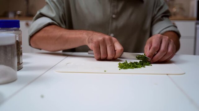 A chef professionally prepares a fresh vegetable salad, chopping potatoes, eggs, and greens. Dynamic cooking process showcasing culinary skills and healthy food preparation
