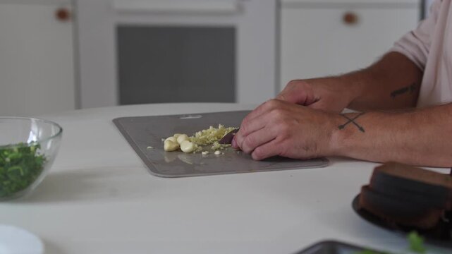 A chef professionally prepares a fresh vegetable salad, chopping potatoes, eggs, and greens. Dynamic cooking process showcasing culinary skills and healthy food preparation
