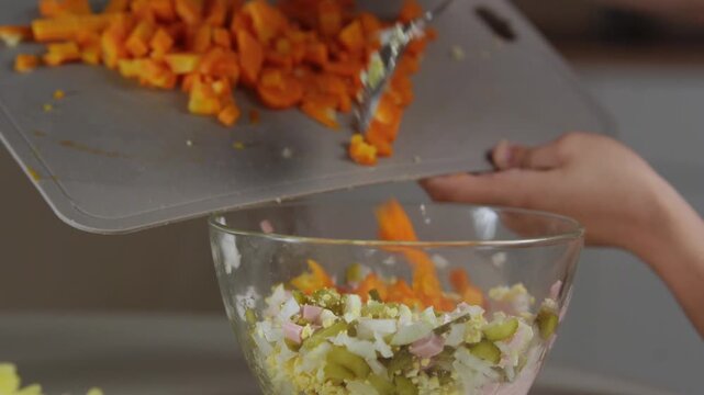 A chef professionally prepares a fresh vegetable salad, chopping potatoes, eggs, and greens. Dynamic cooking process showcasing culinary skills and healthy food preparation