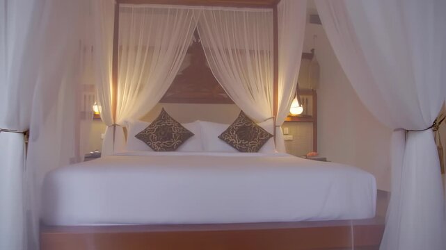 Luxurious bedroom with a four-poster bed, draped in sheer white curtains