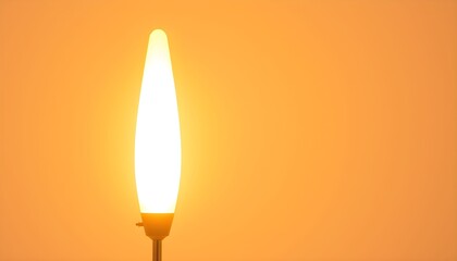 Illuminated LED lamp with a flame-like shape against an orange background, emitting a warm glow.