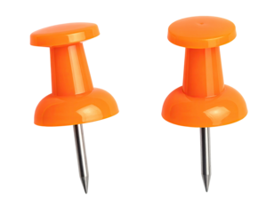 Two bright orange pushpins, metallic silver tacks, isolated on black background