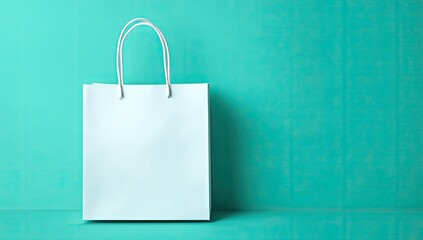 Light teal paper shopping bag against turquoise background