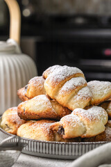 Mini croissant cottage cheese cookies with poppy seed filling and powdered sugar on top. Delicious homemade dessert bagels