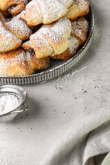 Mini croissant cottage cheese cookies with poppy seed filling and powdered sugar on top. Delicious homemade dessert bagels