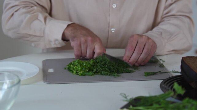 A chef professionally prepares a fresh vegetable salad, chopping potatoes, eggs, and greens. Dynamic cooking process showcasing culinary skills and healthy food preparation