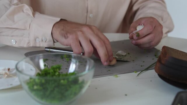 A chef professionally prepares a fresh vegetable salad, chopping potatoes, eggs, and greens. Dynamic cooking process showcasing culinary skills and healthy food preparation