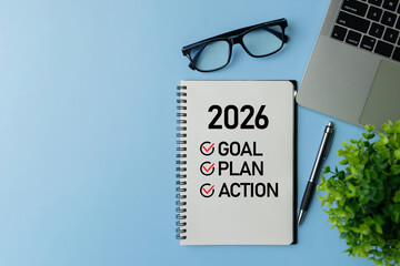 Notebook reading 2026 with checklist Goal, Plan, Action beside glasses, laptop, pen and green plant, symbolizing business planning, strategy roadmap, productivity and execution for the new year.
