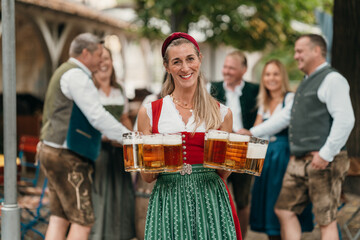 Smiling waitress in Bavarian attire offers mugs of beer to group of friends celebrating Oktoberfest in a lively beer garden atmosphere