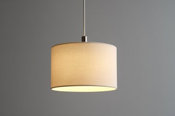 Simple cream-colored pendant light against a neutral background