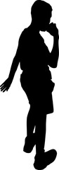 Silhouette of a young  boy walking while eating 
