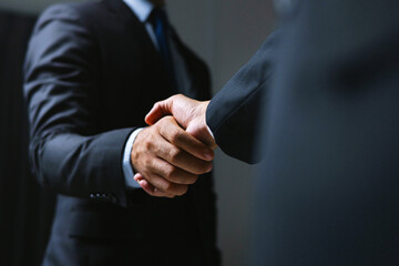 Two men shaking hands in  business setting
