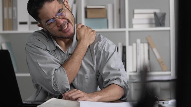Businessman having neck ache and shoulder pain from working in the office