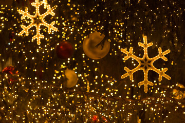 Glowing decorative snowflake in close up, used as a Christmas background element with festive illumination.