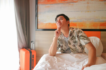 Young asian man waking up and planning his day in bed lifestyle image