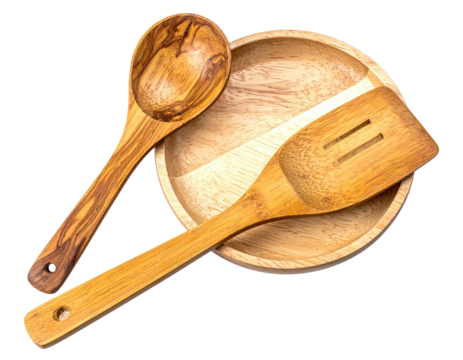 Wooden cooking utensils?a spoon and spatula resting on a round bowl