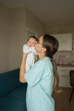 Mother kissing baby at home