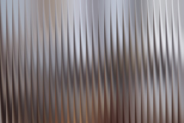 Obraz premium Abstract metallic background with vertical pleats and soft lighting