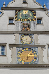 The clock tower of the Ratstrinkstube or Councilor’s Tavern, a historic gem located at Marktplatz in Rothenburg ob der Tauber, Germany, right near the Grüner Markt and springs to life every hour.