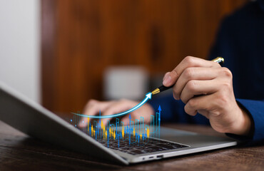 Businessman analyzing digital growth chart with rising arrow on laptop, symbolizing financial success, investment strategy, business growth, data analytics, and economic development.