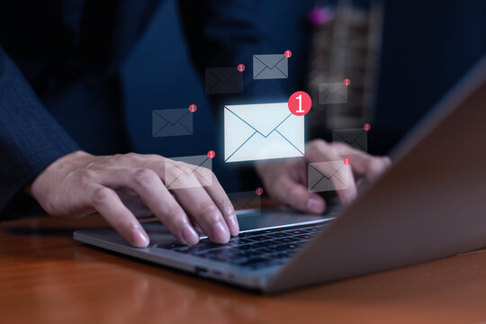 Businessman typing on laptop with digital email icons and notification alerts symbolizing online communication, email marketing, corporate messaging, technology, and digital business connection.