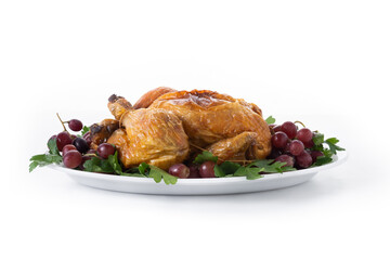 Roast turkey with grapes and parsley on white plate isolated on white background