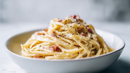 Fototapeta premium Delicious spaghetti carbonara in a white bowl, tempting dish, savory meal