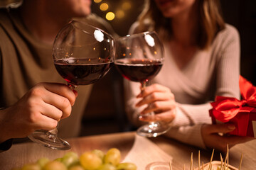 Young Couple in love drinking red wine. Romantic date at night. Toast. Dinner for couple on Valentine's day.