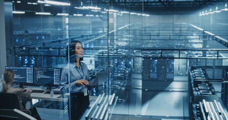 Asian Female Information Technology Engineer Reviews Security Logs on Her Laptop Computer in a High-Tech Data Center, Analyzing Potential Risks to Ensure Network’s Safety and Compute Power
