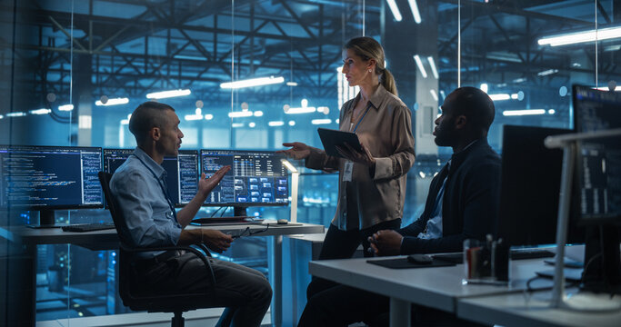 Gathered for a Briefing, Three Diverse Team Members, Two Men and a Female Team Leader Reviewing Project Requirements and Commercial Opportunities in the High-Tech Data Center Office - Powered by Adobe