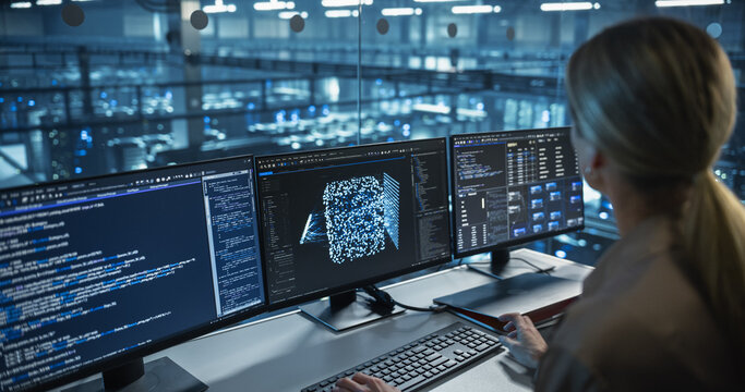 With Multiple Screens Open to Code and Analyze Neural Network Visualizations, Female Software Developer in a Data Center Refines an AI Algorithm, Working Methodically to Improve Performance