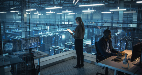 Female Information Technology Engineer Reviews Security Logs on Her Tablet Computer in a High-Tech Data Center, Analyzing Potential Risks to Ensure Network’s Safety and Compute Power
